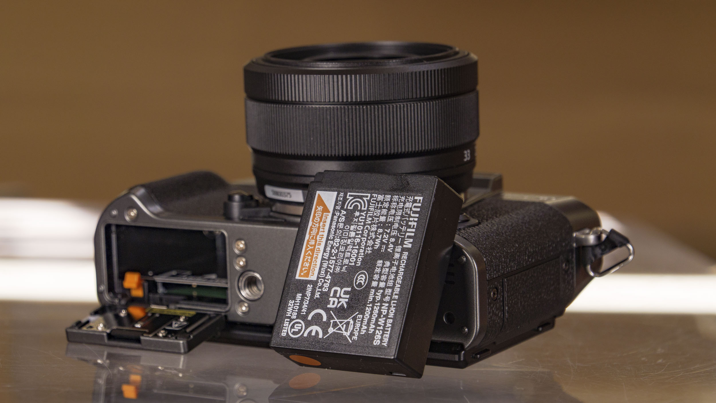 Fujifilm X-T30 III camera on a glass table, battery removed