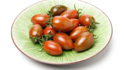 small variety of oval shaped tomatoes in a bowl 
