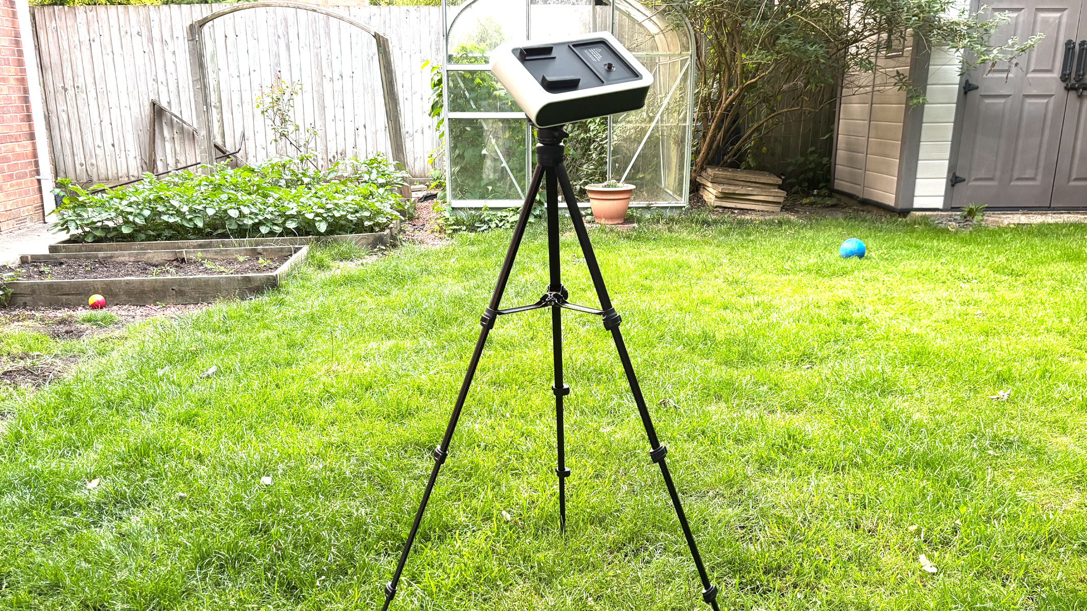 The Vaonis Hestia on a tripod in a garden.