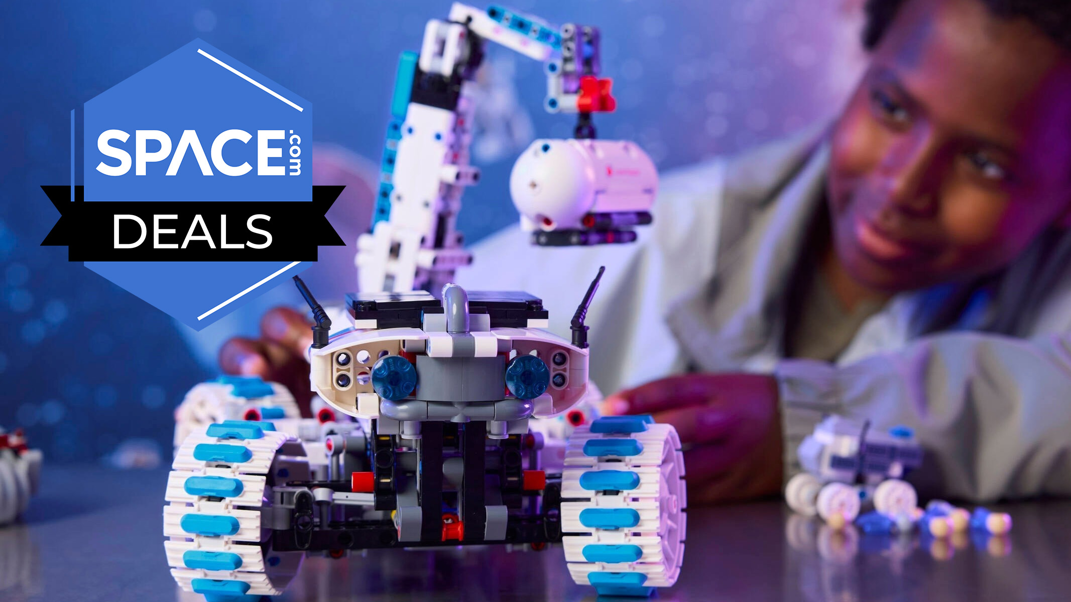 A boy playing with the Lego Technic Lunar Outpost Moon Rover Space Vehicle