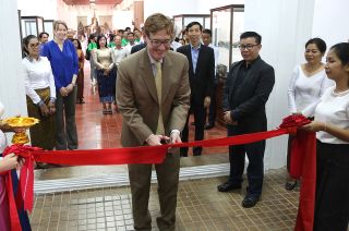 Michael Newbill, Deputy Chief of Mission at the U.S. Embassy in Cambodia, cuts the ribbon opening the goodwill moon rock exhibit at the National Museum of Cambodia on June 18, 2018.
