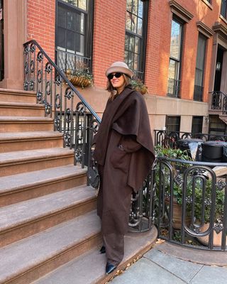 Fashion influencer @cocoschiffer in New York City wearing a chic winter outfit featuring the "straight out of a Nora Ephron movie" micro-trend.