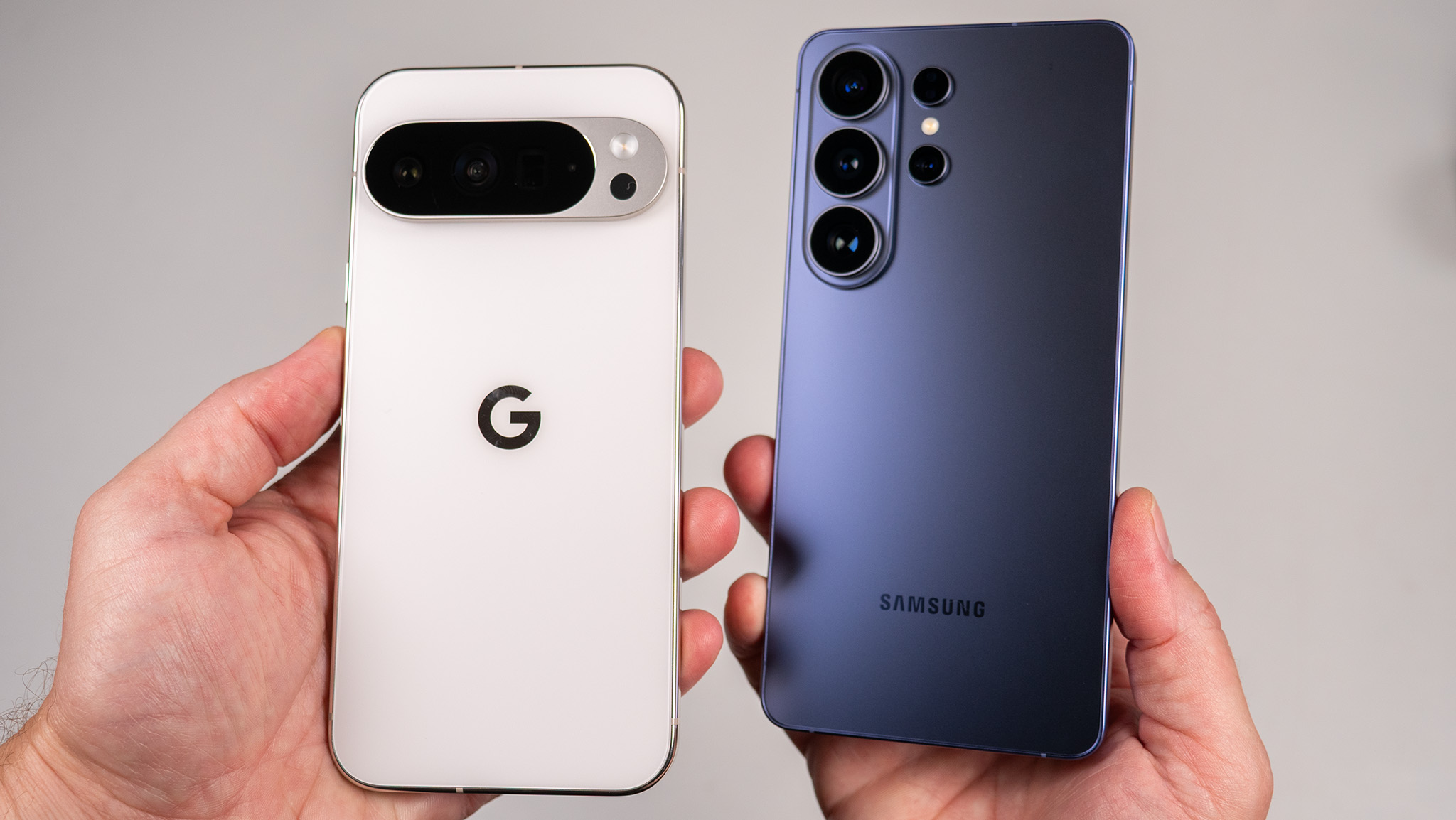 Comparing the back of the white Google Pixel 10 Pro XL with the blue Samsung Galaxy S26 Ultra