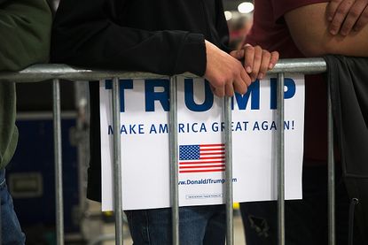 A Donald Trump supporter holds a Trump 2016 campaign sign.