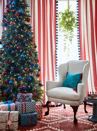 Christmas tree decorated in red, white and blue ornaments