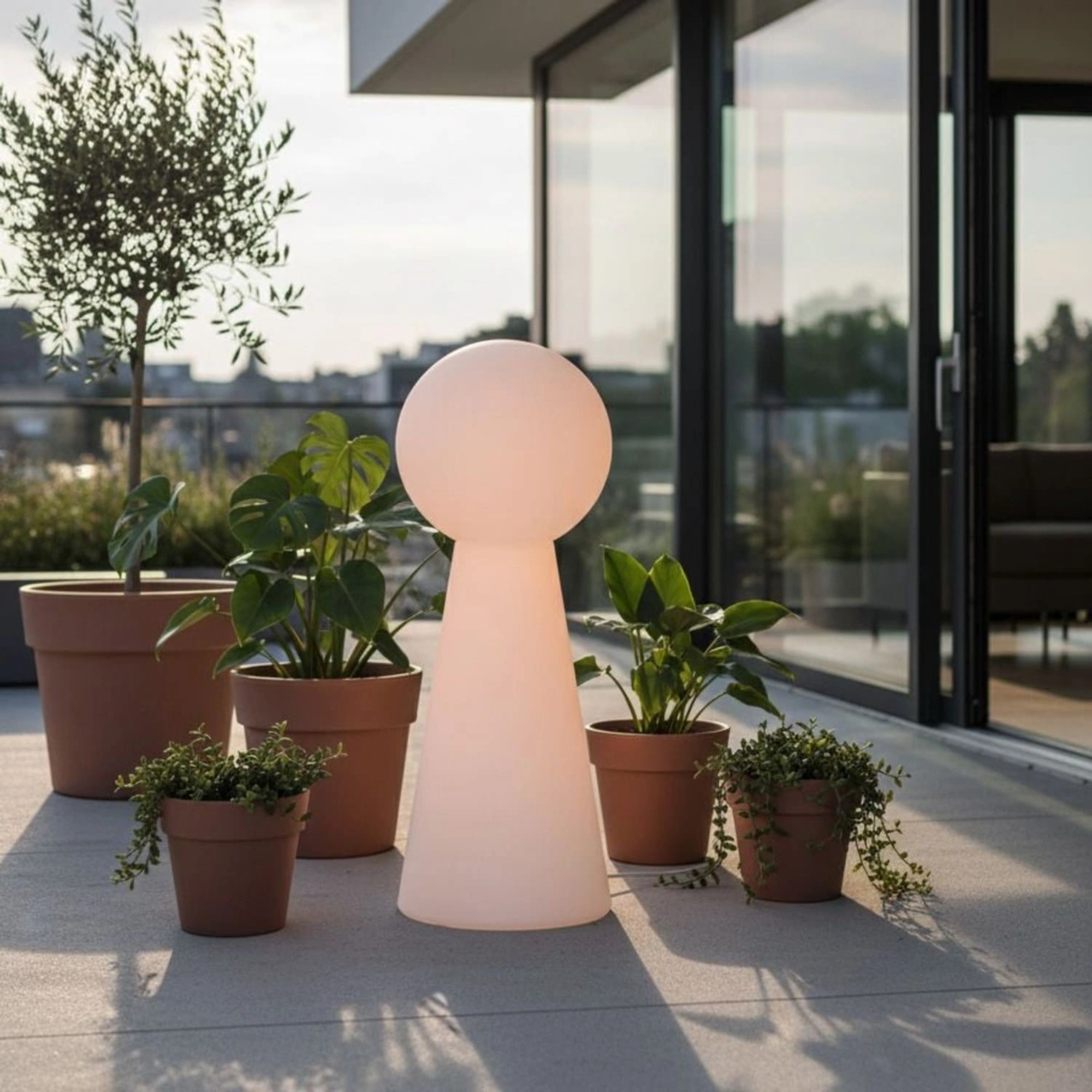 Wyld and Coco Outdoor LED Floor Lamp White RGB IP54 on a terrace surrounded by plant pots