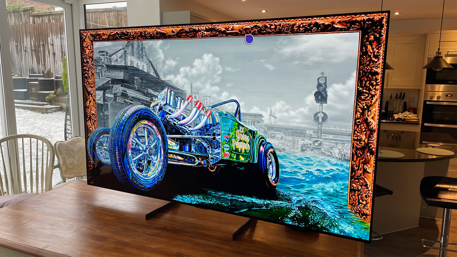 8K OLED TV: LG OLED77Z3 on a kitchen table with a car on screen
