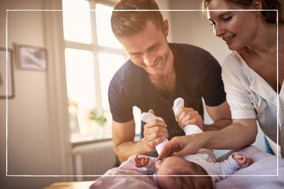 parents playing with their young baby