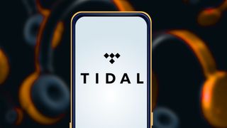 Tidal logo on phone with headphones in the background