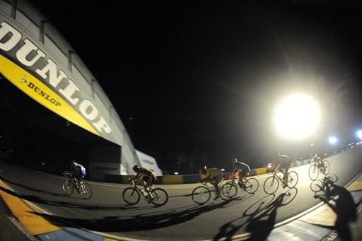 Riders pass under the famous Dunlop bridge on the Le Mans course.