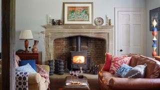 living room with lit woodburner in 14th century manor house