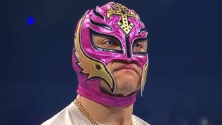 Rey Mysterio staring down Dominik Mysterio in the ring. 
