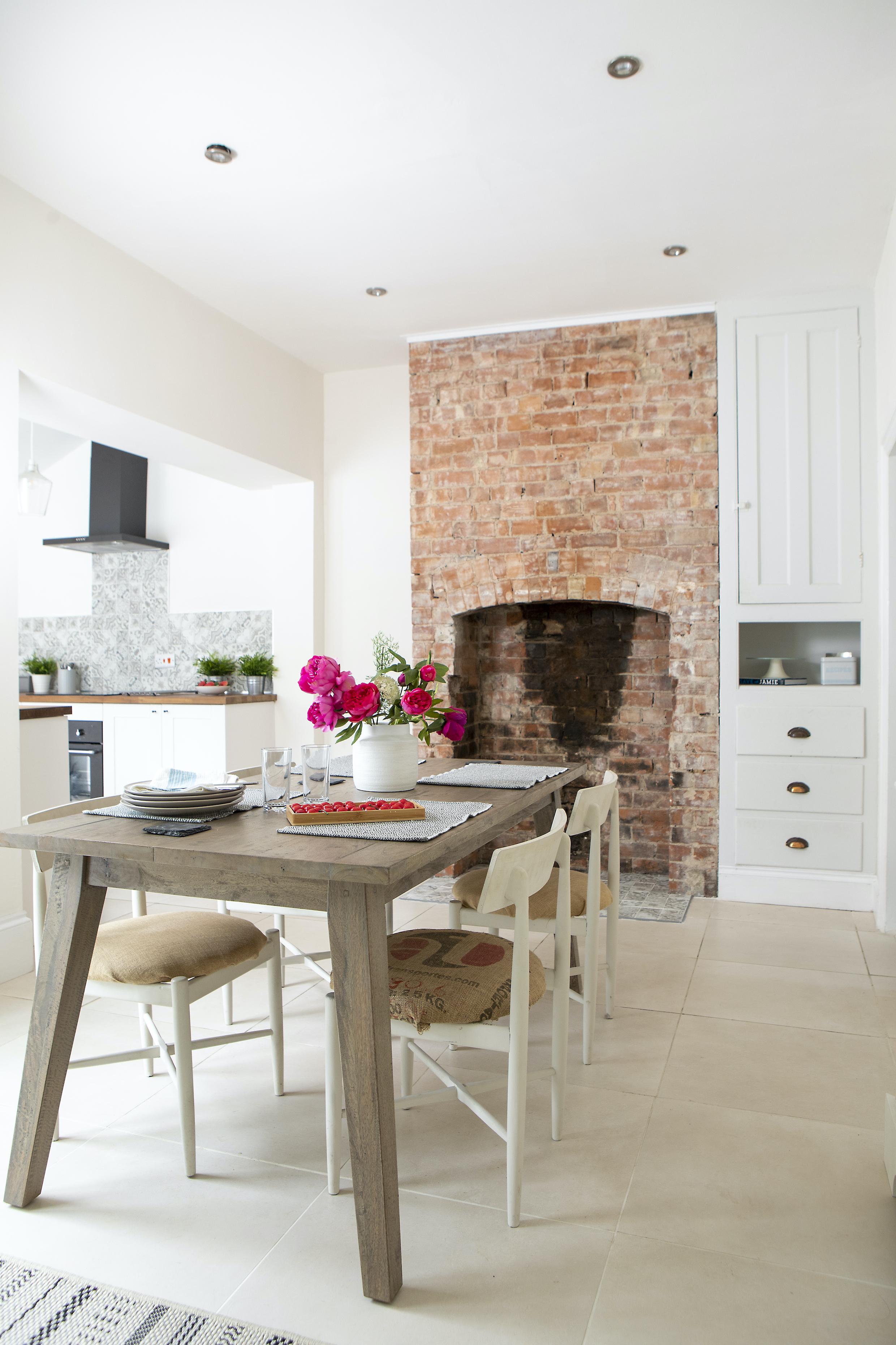 a brick chimney breast with built in cupboard