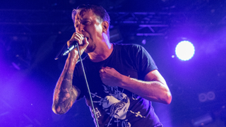 Lou Koller singing with Sick Of It All onstage in 2022