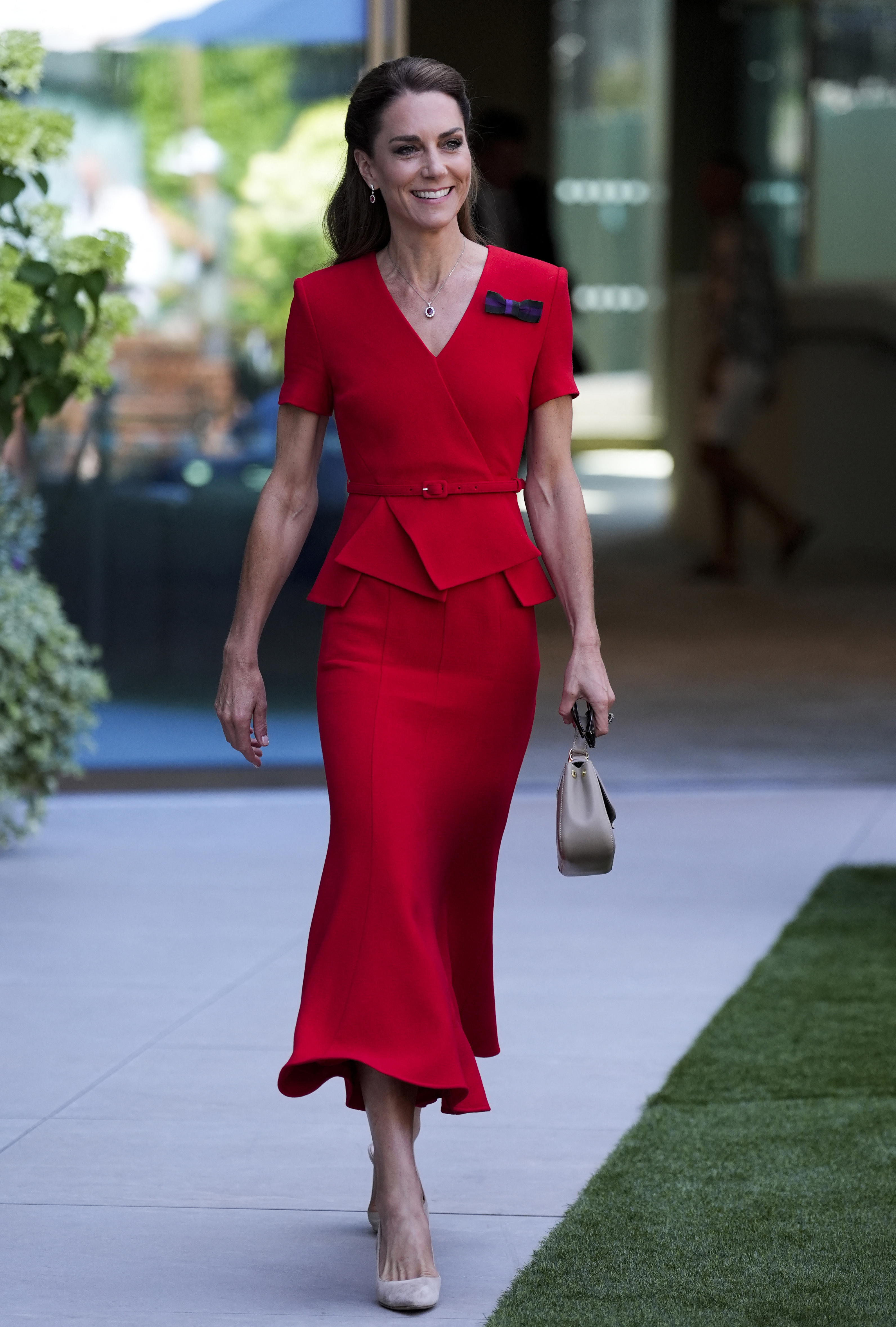 Kate Middleton wears a bright red Roland Mouret dress and carries a taupe bag at Wimbledon on July 11, 2026
