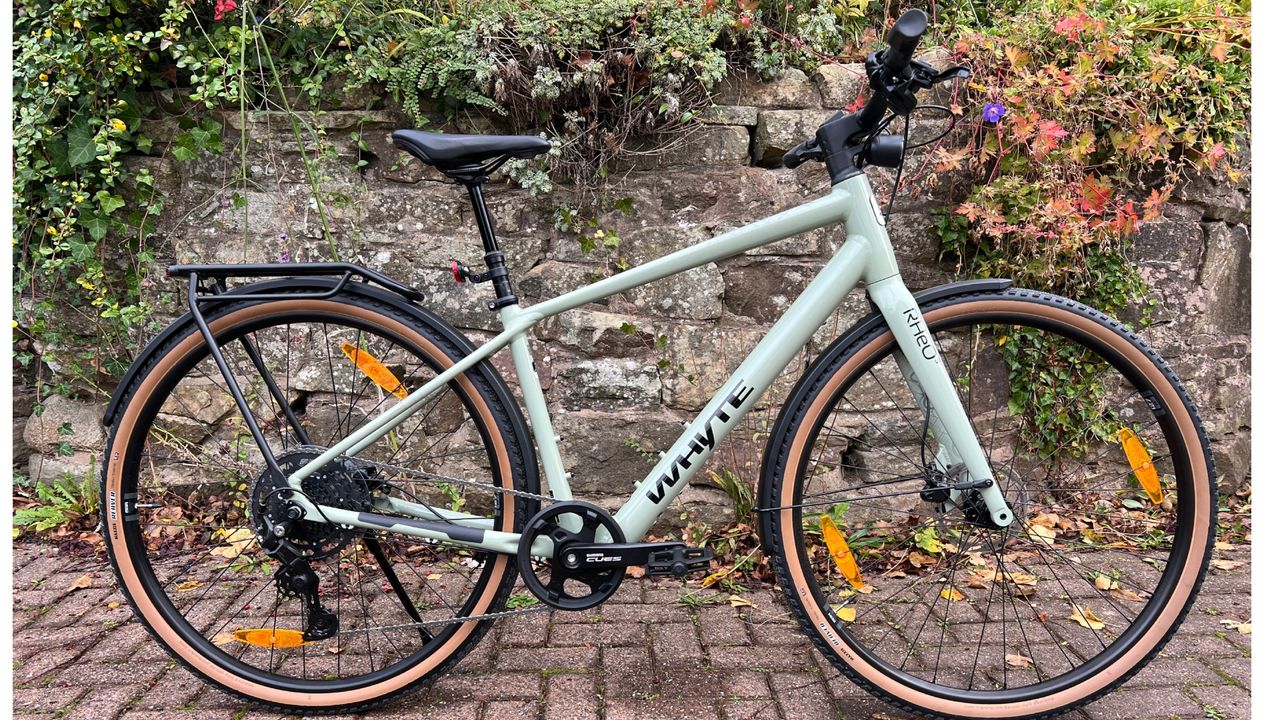 The Whyte RHeO 3 ebike side on in front of a stone wall