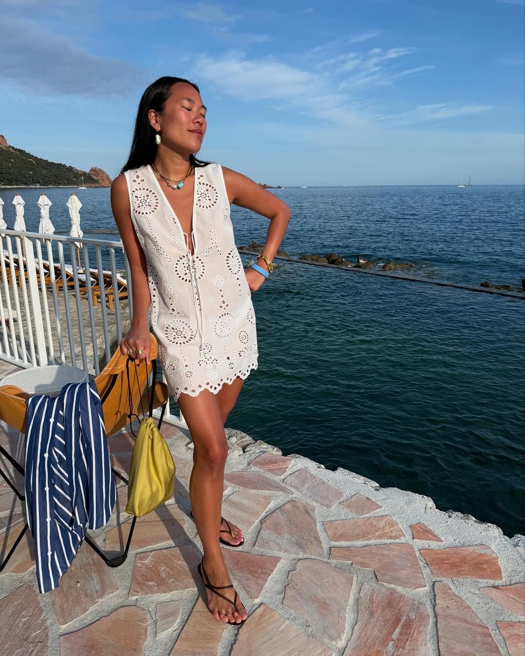 Woman wearing a broderie anglaise dress.