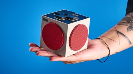 A beige, red and black 8BitDo Retro Cube 2 Bluetooth speaker