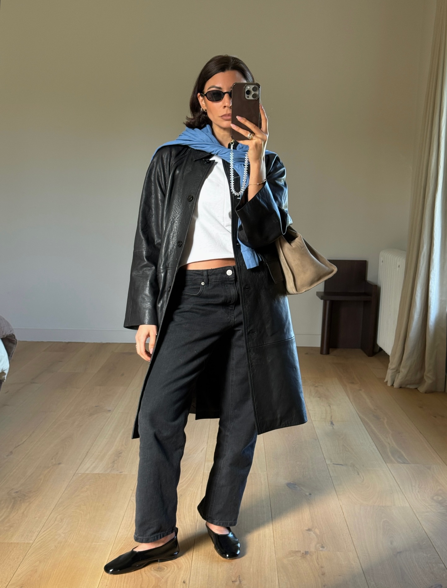 Marianne Smyth wears a leather trench coat, black jeans and ballet flats