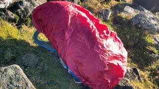 The Highlander Vorlich rucksack on the ground with the rain cover on it