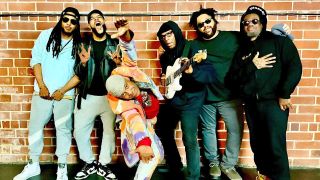 Fishbone posing against a brick wall