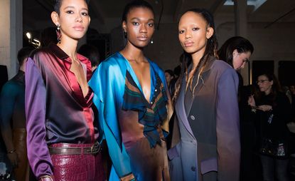 three woman wearing fashionable clothes