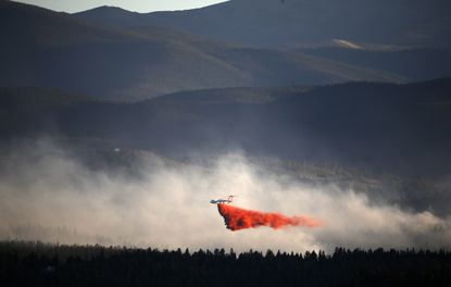 A plane drops retardant while battling the Cold Springs Fire near Nederland, Colorado.