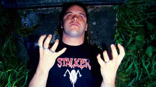 Cannibal Corpse posing for a photograph in a graveyard