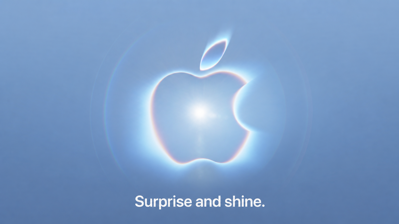 A blue image with a shining Apple logo in the centre and the words 'surprise and shine' underneath