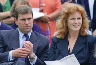 Prince Andrew wearing a blue suit sitting next to Sarah Ferguson at a 1993 sports day