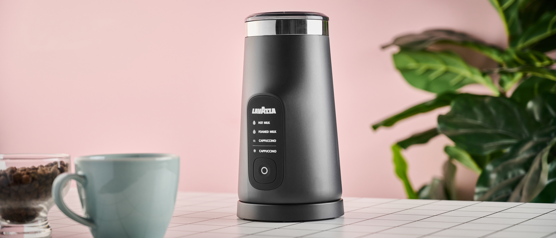 Lavazza MilkEasy Plus on table with mug and coffee beans