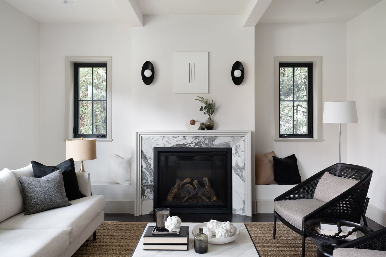 a modern living room with a marble fireplace