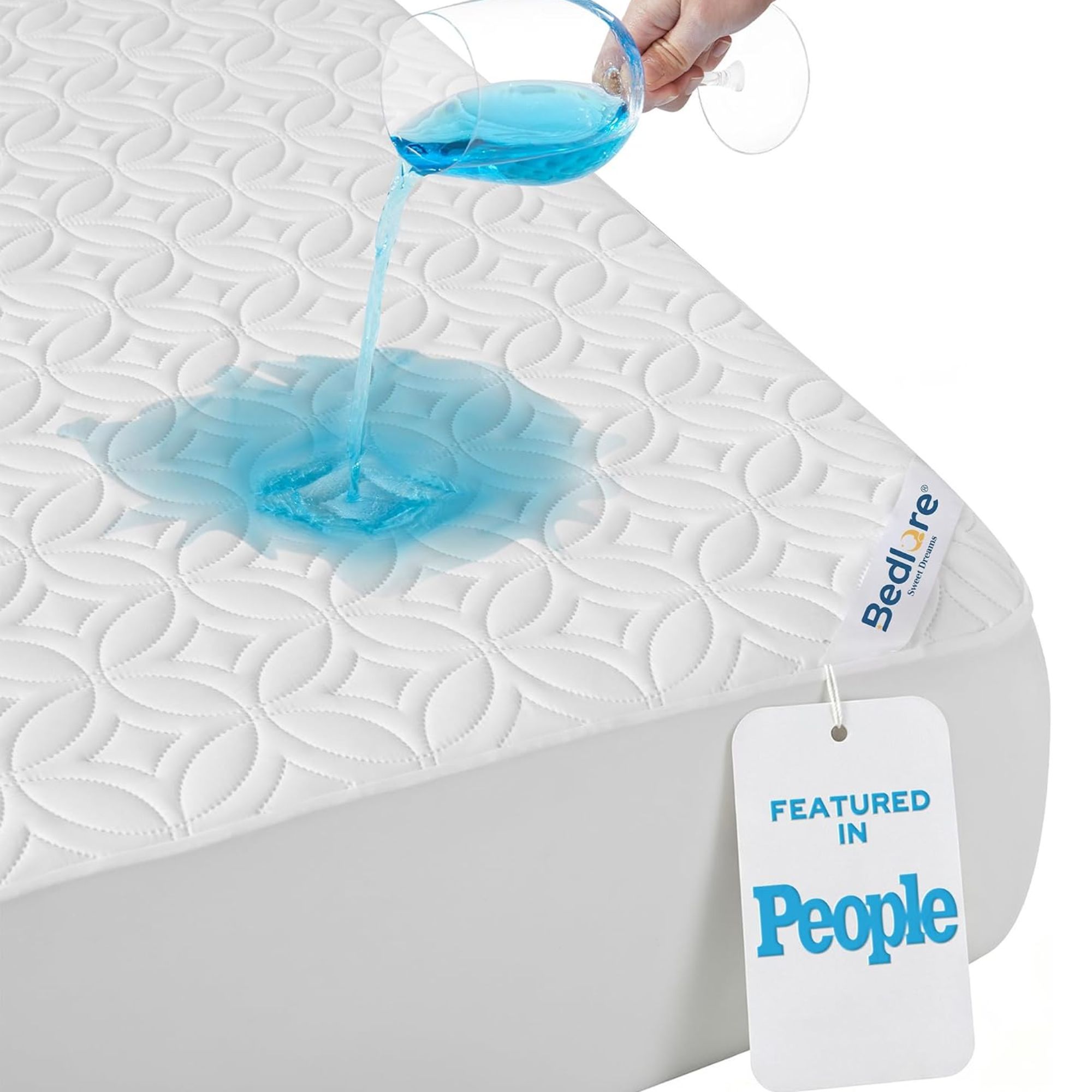 BEDLORE Waterproof Mattress Protector pictured on a mattress with a hand holding a wine glass pouring blue liquid onto it.