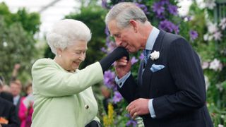 Queen Elizabeth II presents Prince Charles, Prince of Wales with the Royal Horticultural Society's Victoria Medal of Honour during a visit to the Chelsea Flower Show on May 18, 2009 in London.