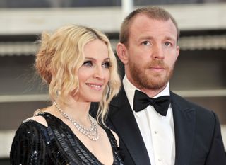 Madonna (L) and her husband British director Guy Ritchie pose as they arrive to attend the screening of Nathan Rissman's film 'I Am Because We Are