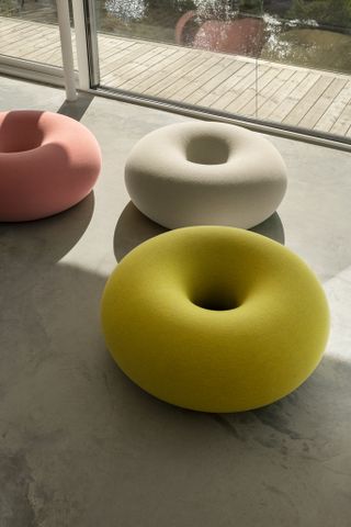 Three donut shaped poufs by Sabine Marcelis for Hem in yellow, pink and white, featured as one of Rosa Bertoli's best furniture launches of 2021