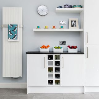 kitchen with white shelf fruit and white wall