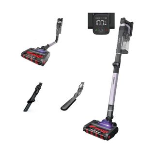 A Shark Stratos cordless vacuum with a silver handle and black brush head with purple lights coming out of it, plus three black and silver head accessories to the left of it