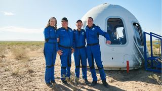 The passenger crew of Blue Origin's NS-18 space tourist flight poses with their New Shepard capsule after landing back on Earth on Oct. 13, 2021. They are: (from left): Audrey Powers, William Shatner, Chris Boshuizen and Glen de Vries.