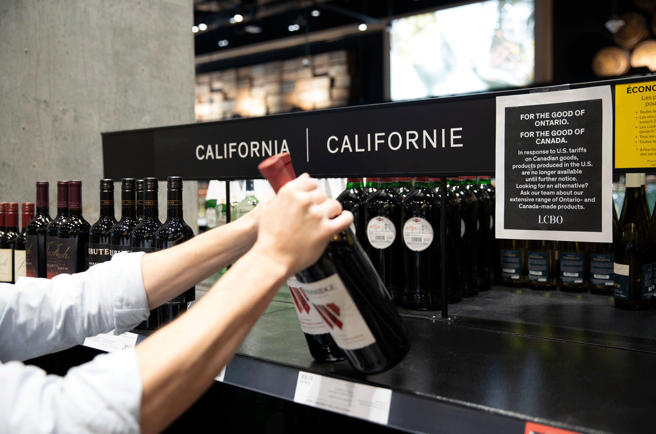 Image of a clerk taking wines of the shelf