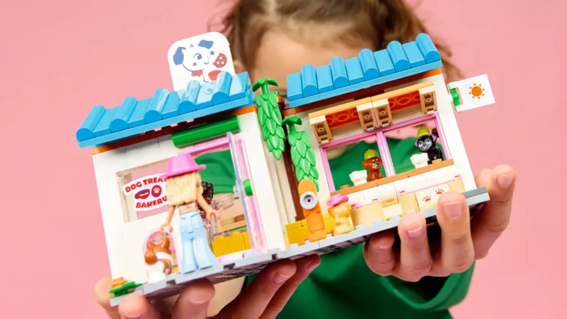 A child holds out a Lego set