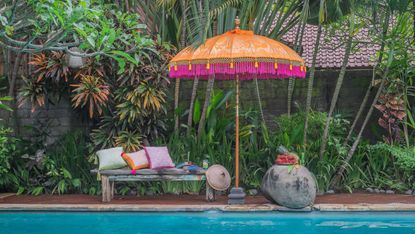 tropical garden ideas with etta parasol from east london parasol company next to swimming pool