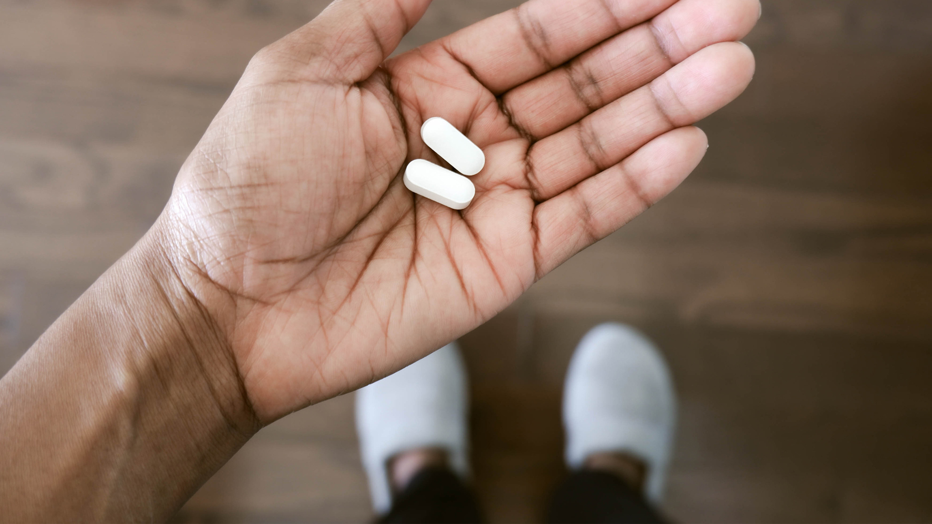 person holding supplements in their hand