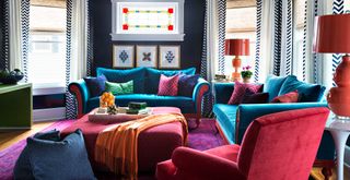 colorful living room with colored furniture to chanel the maximalist decor trend. in style