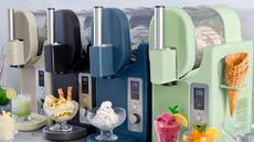 The GreenPan Frost Pro ice cream maker in green, blue, black, and beige lined up on a counter with ice cream in bowls beneath them. 