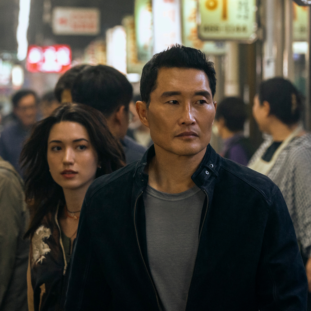 Two people (Reina Hardesty and Daniel Dae Kim, center) walk through a crowded Korean night market, in &#039;Butterfly.&#039;