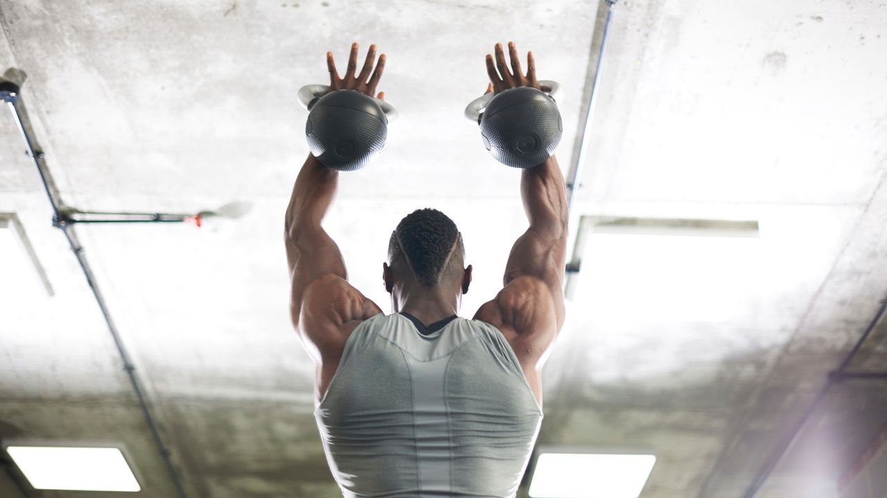 a man doing kettlebell thrusters