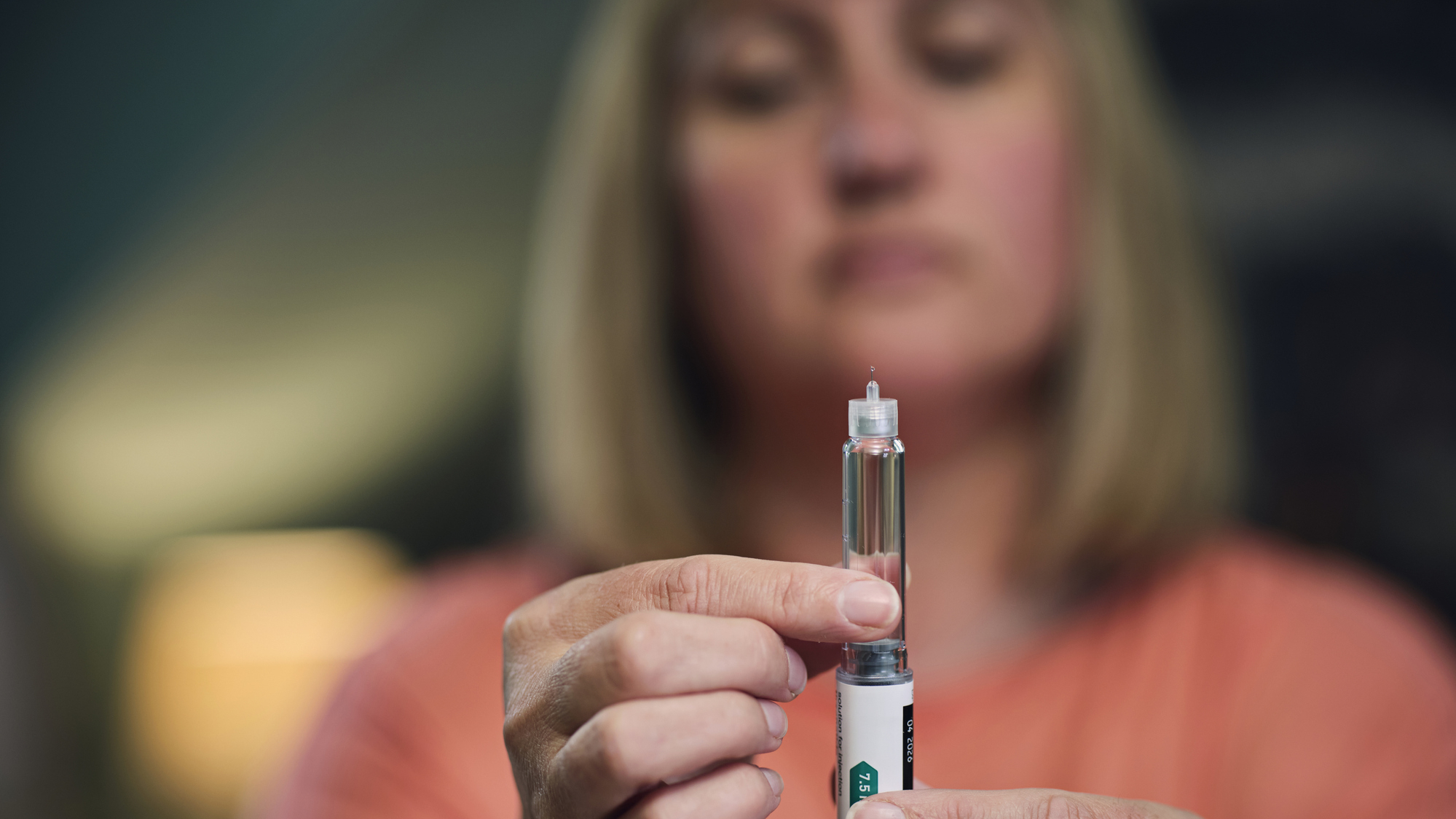 Woman holds GLP-1 pen