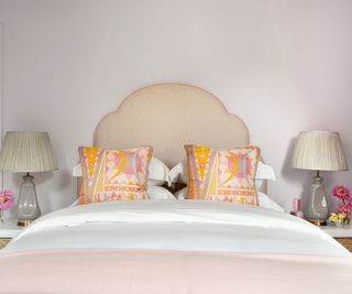 bedhead with apricot patterned cushions and blush blanket