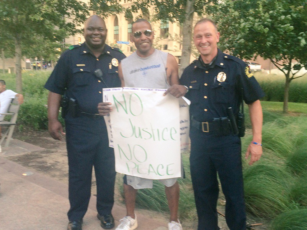 Dallas Police officers and a protester before the shooting Thursday night.
